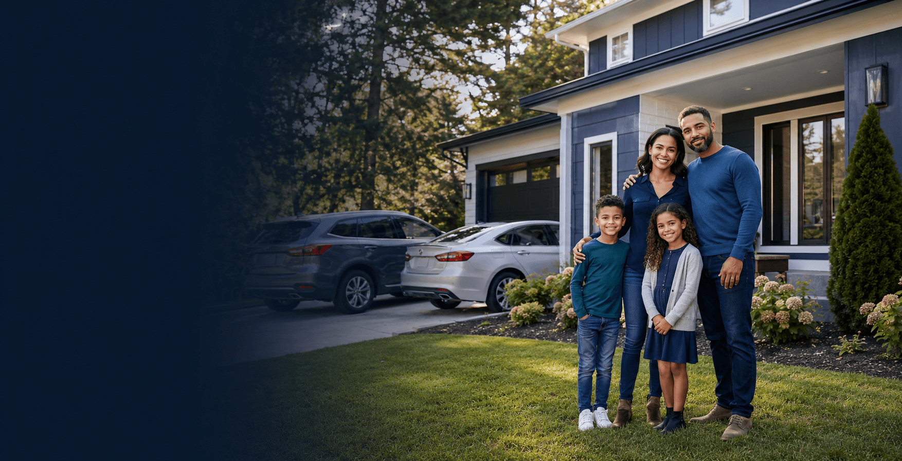 A family smiling together in front of their home and cars in the driveway